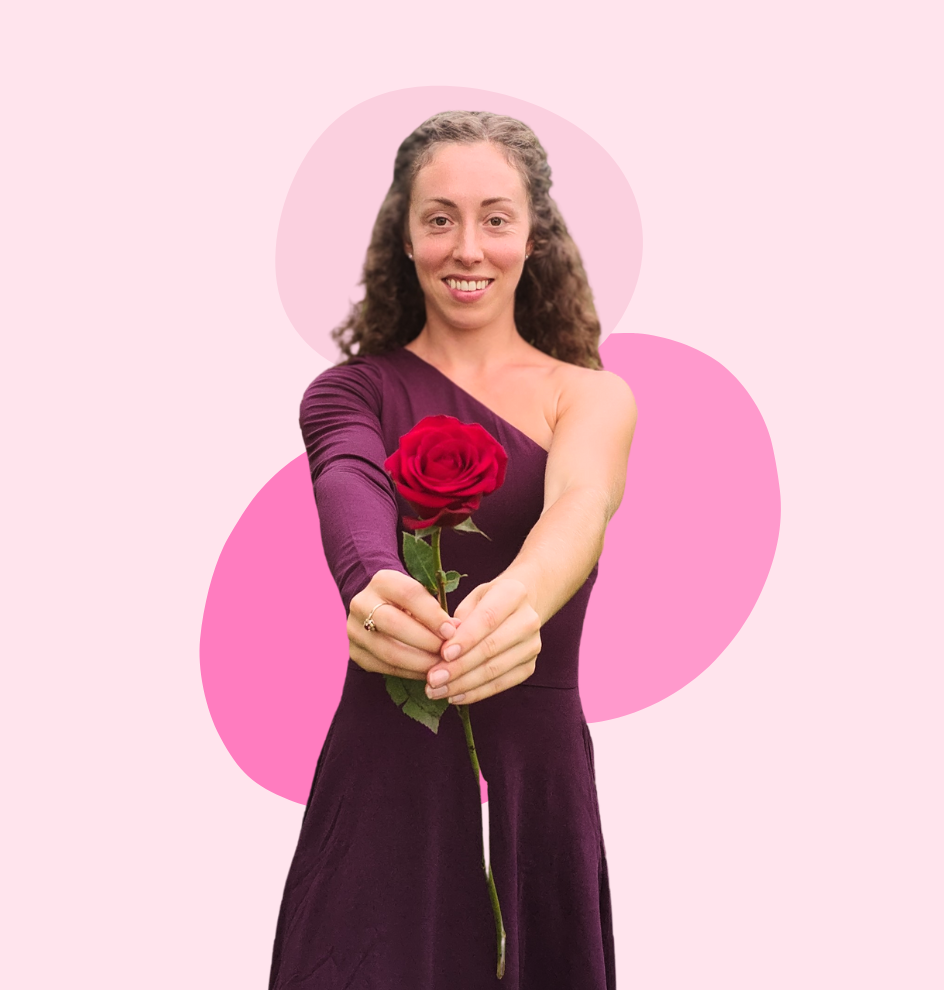 Ann-Marie, the Love Coach, is handing a red rose.